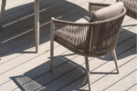 Modern woven outdoor chair with curved aluminum backrest